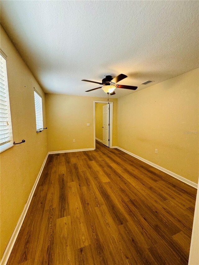 1115 Deer Creek Blvd, Davenport, FL 33837 - spare room featuring wood finished floors, ceiling fan, and a textured ceiling