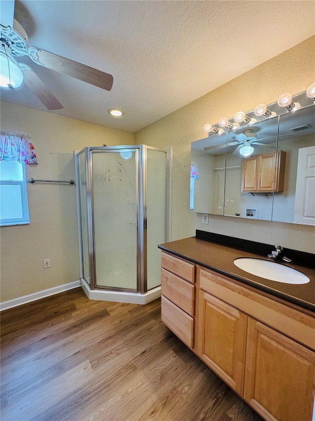 1115 Deer Creek Blvd, Davenport, FL 33837 - bathroom with ceiling fan, a shower stall, vanity, wood finished floors, and a textured ceiling