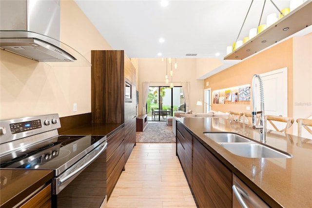 7478 Brooklyn Dr, Kissimmee, FL 34747 - kitchen with stainless steel appliances, island exhaust hood, modern cabinets, open floor plan, and light wood-style floors