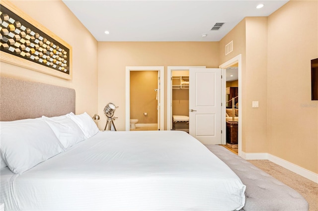 7478 Brooklyn Dr, Kissimmee, FL 34747 - bedroom featuring a spacious closet, connected bathroom, light colored carpet, and recessed lighting