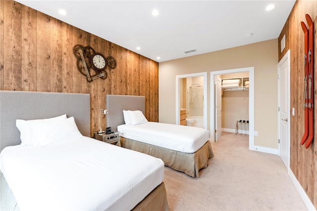 7478 Brooklyn Dr, Kissimmee, FL 34747 - bedroom featuring wood walls, light carpet, recessed lighting, a walk in closet, and ensuite bath