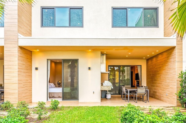 7478 Brooklyn Dr, Kissimmee, FL 34747 - back of house featuring stucco siding and a patio