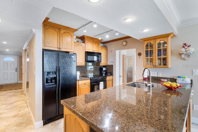 5201 S Atlantic Ave Unit 703A, New Smyrna Beach, FL 32169 - kitchen with black appliances, crown molding, glass insert cabinets, a peninsula, and dark stone countertops