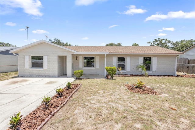 105 E Magnolia St, Davenport, FL 33837 - ranch-style home featuring brick siding and concrete driveway