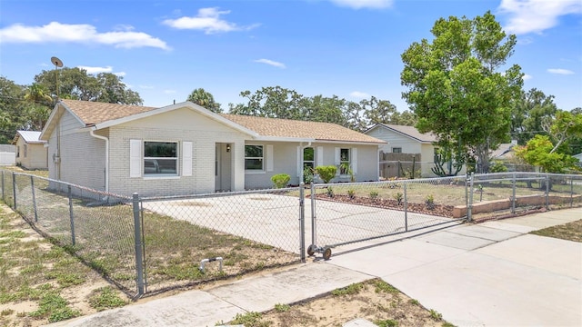 105 E Magnolia St, Davenport, FL 33837 - ranch-style home with a fenced front yard, a gate, brick siding, and covered porch