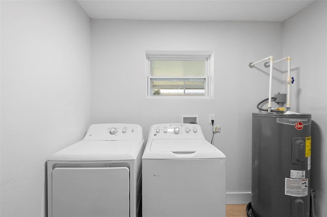 105 E Magnolia St, Davenport, FL 33837 - washroom with electric water heater, separate washer and dryer, and wood finished floors
