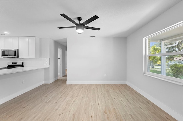 105 E Magnolia St, Davenport, FL 33837 - unfurnished living room with light wood-style flooring, ceiling fan, and recessed lighting