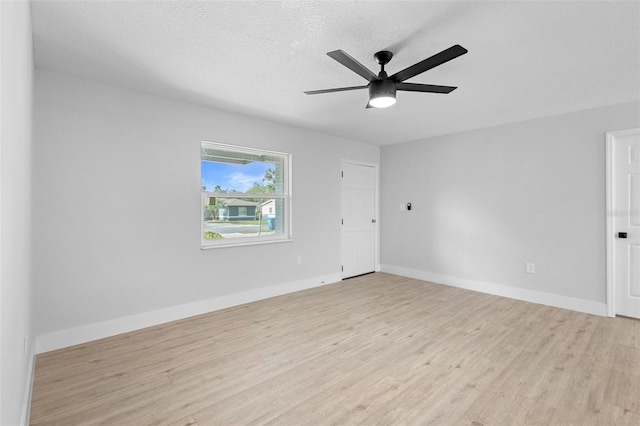 105 E Magnolia St, Davenport, FL 33837 - unfurnished room with light wood finished floors, a ceiling fan, and a textured ceiling