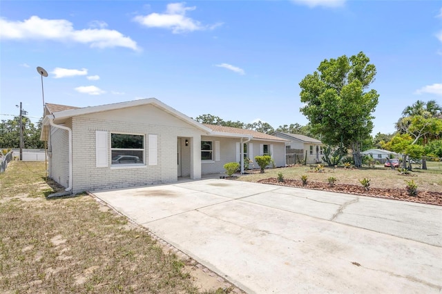105 E Magnolia St, Davenport, FL 33837 - single story home with brick siding and concrete driveway
