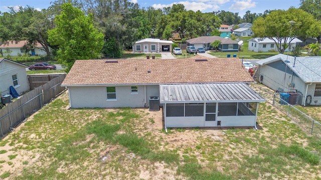 105 E Magnolia St, Davenport, FL 33837 - back of property with a sunroom, a fenced backyard, a residential view, and brick siding