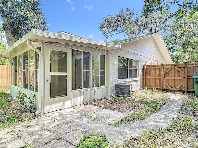 809 Sugar House Blvd, Port Orange, FL 32129 - back of house with a gate, a patio area, and a sunroom