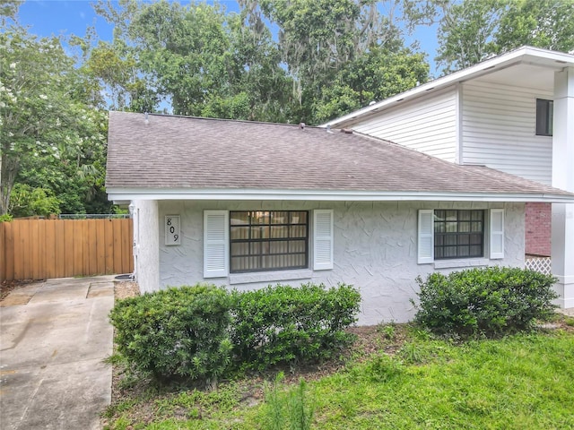 809 Sugar House Blvd, Port Orange, FL 32129 - view of side of property featuring a shingled roof and stucco siding