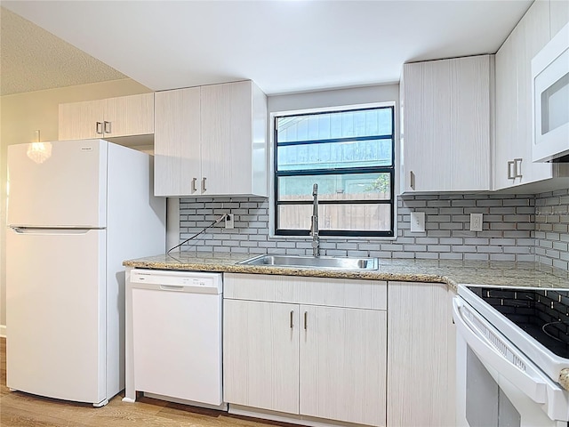 809 Sugar House Blvd, Port Orange, FL 32129 - kitchen with white appliances, light wood-style floors, decorative backsplash, and light stone counters