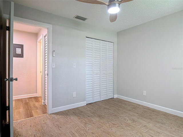 809 Sugar House Blvd, Port Orange, FL 32129 - unfurnished bedroom featuring light wood finished floors, a closet, a ceiling fan, and a textured ceiling