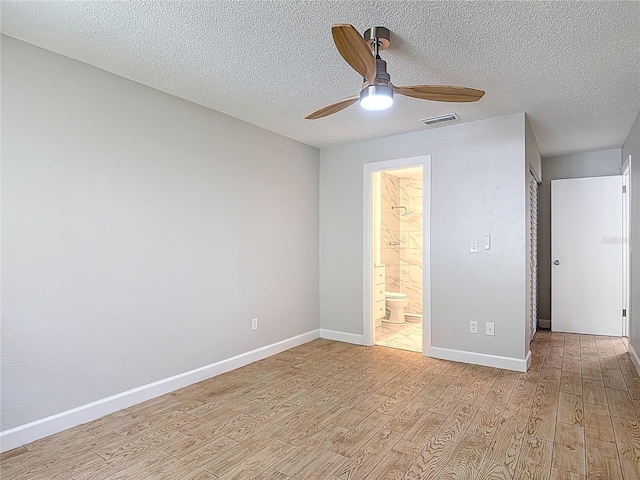 809 Sugar House Blvd, Port Orange, FL 32129 - unfurnished bedroom featuring light wood-style floors, a textured ceiling, ensuite bathroom, and ceiling fan
