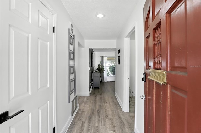 2908 Clear Way, Orlando, FL 32805 - hallway with light wood-type flooring and a textured ceiling