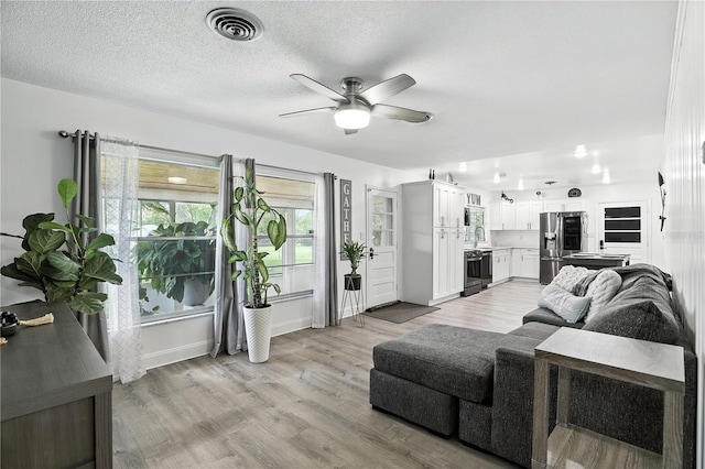 2908 Clear Way, Orlando, FL 32805 - living room featuring ceiling fan and light wood-style flooring