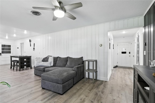 2908 Clear Way, Orlando, FL 32805 - living room with ceiling fan, light wood-type flooring, and a textured ceiling