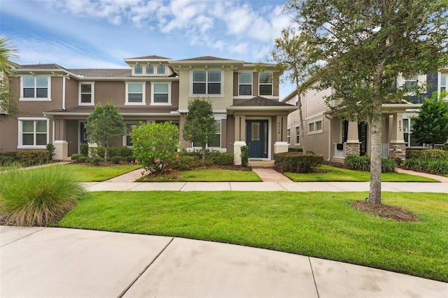 8968 Hildreth Ave, Orlando, FL 32832 - view of front facade with stucco siding and a front lawn
