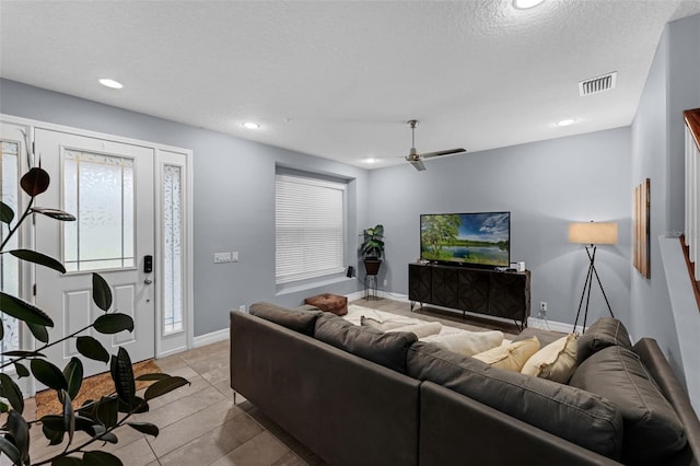 8968 Hildreth Ave, Orlando, FL 32832 - tiled living room with recessed lighting, a ceiling fan, and a textured ceiling