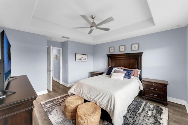 8968 Hildreth Ave, Orlando, FL 32832 - bedroom featuring a tray ceiling, wood finished floors, and ceiling fan