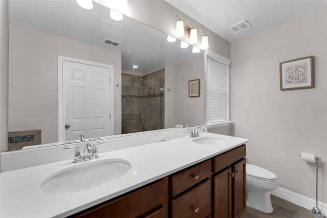 8968 Hildreth Ave, Orlando, FL 32832 - bathroom featuring a shower stall, double vanity, tile patterned flooring, and a textured ceiling