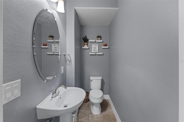 8968 Hildreth Ave, Orlando, FL 32832 - half bathroom featuring a textured ceiling and tile patterned floors