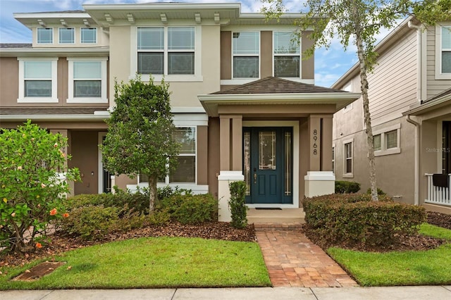 8968 Hildreth Ave, Orlando, FL 32832 - view of front of home featuring stucco siding and a shingled roof