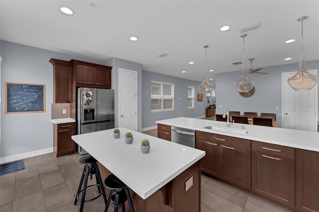 8968 Hildreth Ave, Orlando, FL 32832 - kitchen featuring appliances with stainless steel finishes, light countertops, recessed lighting, a breakfast bar, and pendant lighting