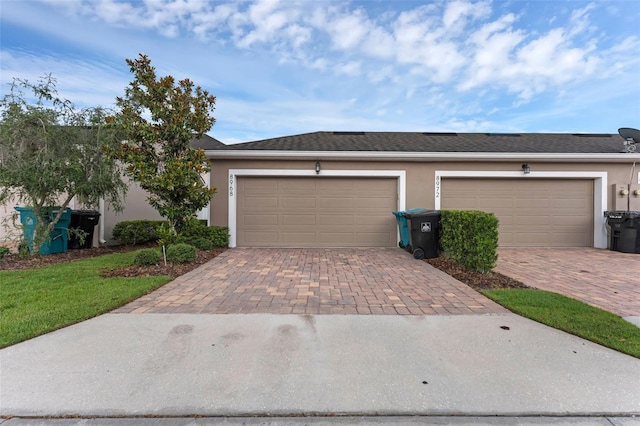 8968 Hildreth Ave, Orlando, FL 32832 - view of front facade with decorative driveway, stucco siding, and a garage
