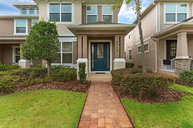 8968 Hildreth Ave, Orlando, FL 32832 - property entrance with stucco siding and a lawn