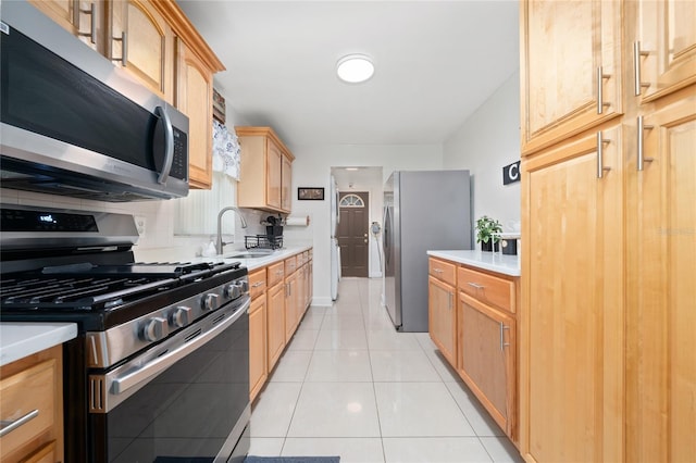 1105 Arrowsmith Ave, Orlando, FL 32809 - kitchen with appliances with stainless steel finishes, light countertops, tasteful backsplash, light brown cabinets, and light tile patterned floors