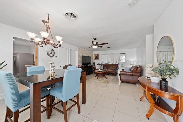 1105 Arrowsmith Ave, Orlando, FL 32809 - dining room with a chandelier, a ceiling fan, and light tile patterned floors