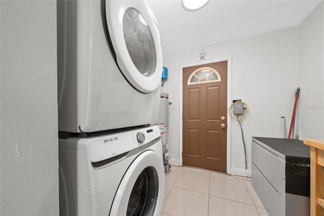 1105 Arrowsmith Ave, Orlando, FL 32809 - laundry room featuring stacked washing machine and dryer, light tile patterned floors, and gas water heater
