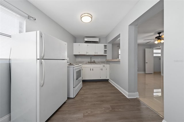 1105 Arrowsmith Ave, Orlando, FL 32809 - kitchen with white appliances, a wall unit AC, white cabinetry, light countertops, and a ceiling fan