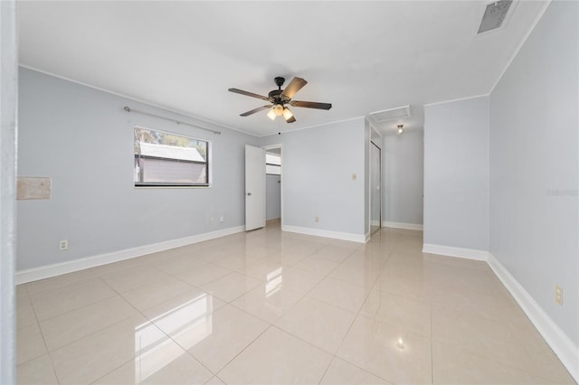 1105 Arrowsmith Ave, Orlando, FL 32809 - spare room with ceiling fan, light tile patterned flooring, attic access, and ornamental molding