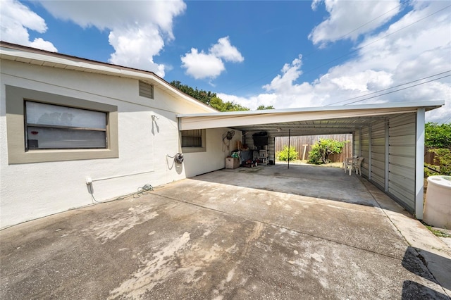 1105 Arrowsmith Ave, Orlando, FL 32809 - view of side of property with concrete driveway, a carport, and stucco siding