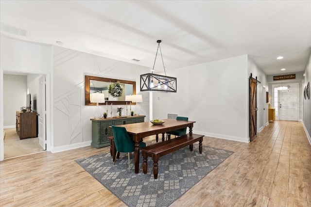 31924 Geoff, Sorrento, FL 32776 - dining room featuring light wood-type flooring, a barn door, and recessed lighting