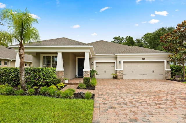 31924 Geoff, Sorrento, FL 32776 - prairie-style house with stucco siding, an attached garage, stone siding, driveway, and a front yard