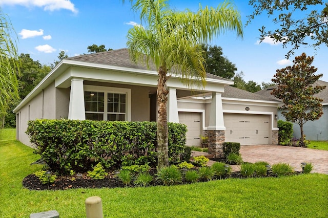 31924 Geoff, Sorrento, FL 32776 - view of front of house with a front lawn, an attached garage, stucco siding, driveway, and roof with shingles