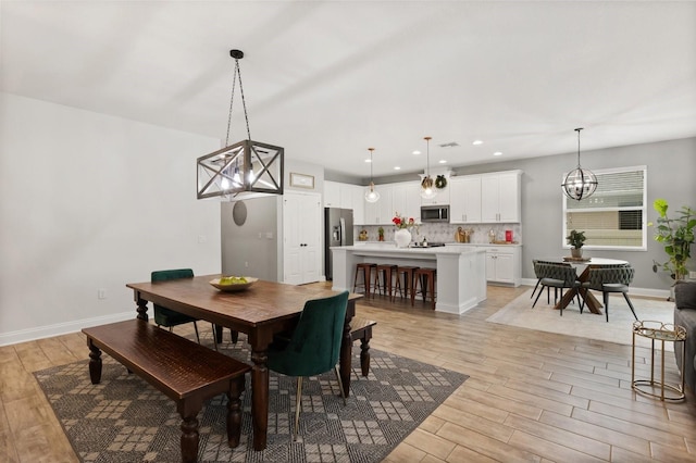 31924 Geoff, Sorrento, FL 32776 - dining area with light wood-style flooring, a chandelier, and recessed lighting