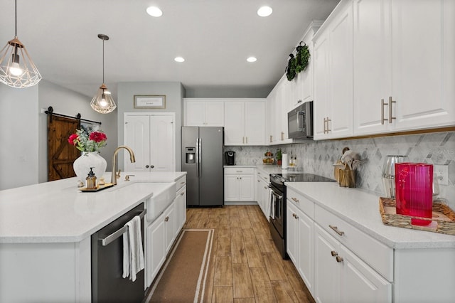 31924 Geoff, Sorrento, FL 32776 - kitchen with black appliances, light wood-style floors, white cabinets, and recessed lighting