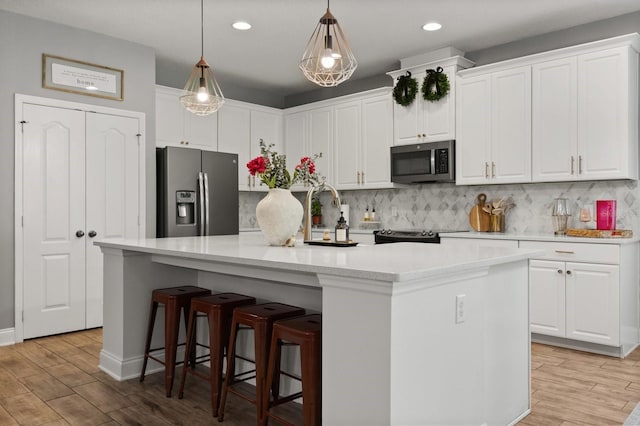31924 Geoff, Sorrento, FL 32776 - kitchen with appliances with stainless steel finishes, white cabinets, light wood-style flooring, backsplash, and recessed lighting