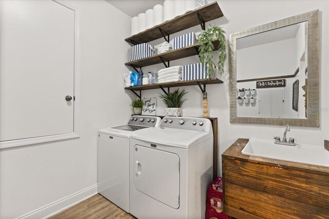 31924 Geoff, Sorrento, FL 32776 - laundry room with washing machine and clothes dryer and light wood-style flooring