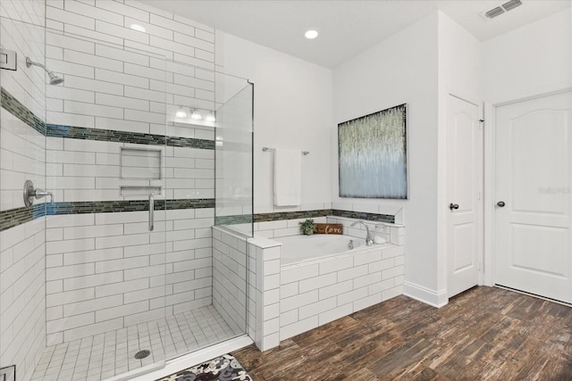 31924 Geoff, Sorrento, FL 32776 - bathroom with a stall shower, a garden tub, wood finished floors, and recessed lighting
