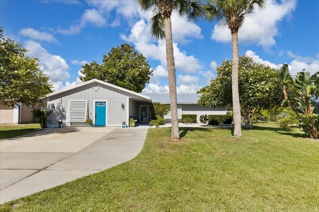 2356 Date Palm Dr, Edgewater, FL 32141 - ranch-style home with driveway and a front yard