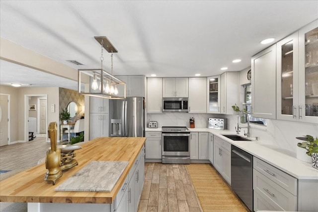 2356 Date Palm Dr, Edgewater, FL 32141 - kitchen featuring stainless steel appliances, butcher block counters, light wood-style floors, a center island, and recessed lighting