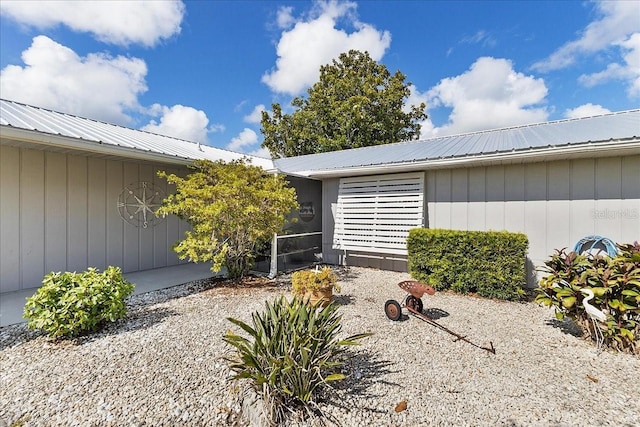 2356 Date Palm Dr, Edgewater, FL 32141 - property entrance with a metal roof