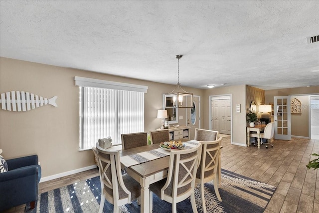 2356 Date Palm Dr, Edgewater, FL 32141 - dining space featuring wood finished floors and a textured ceiling