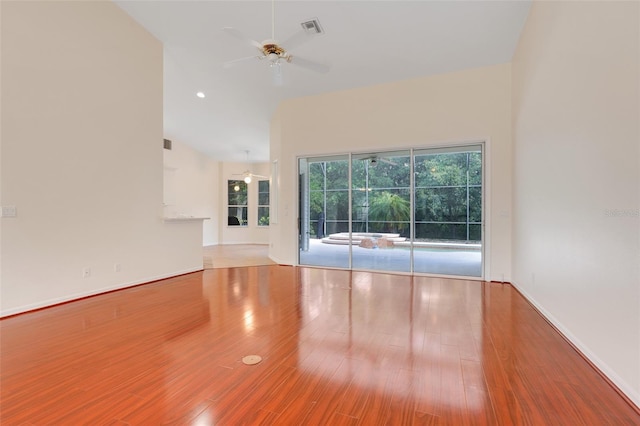 20542 Queen Alexandra Dr, Leesburg, FL 34748 - spare room featuring a ceiling fan, wood finished floors, and high vaulted ceiling